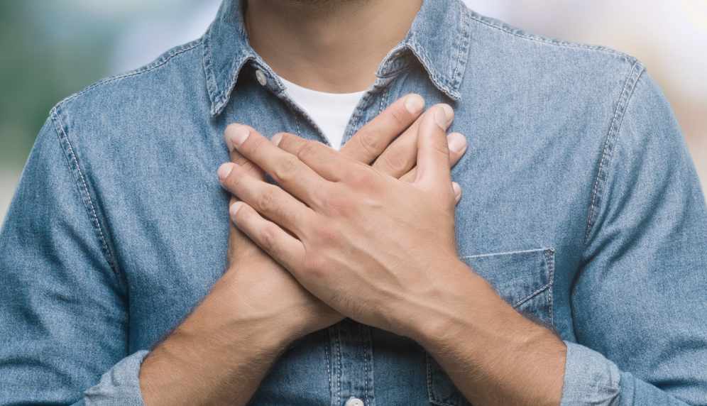 man hands on chest