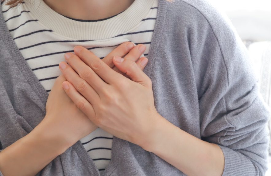 woman hands on chest